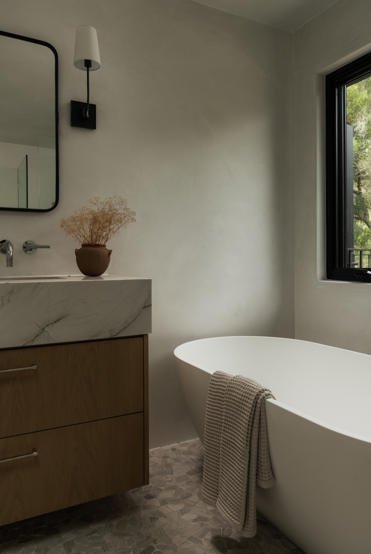 Soaking tub beside the marble vanity