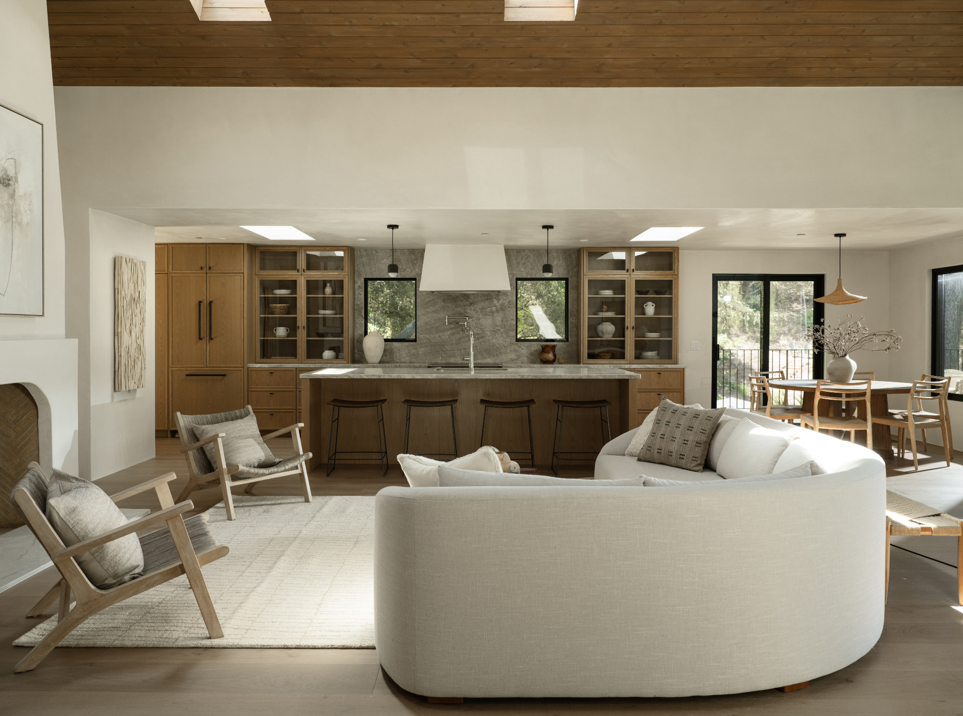 Great room, kitchen, and dining gathered beneath the cedar ceiling