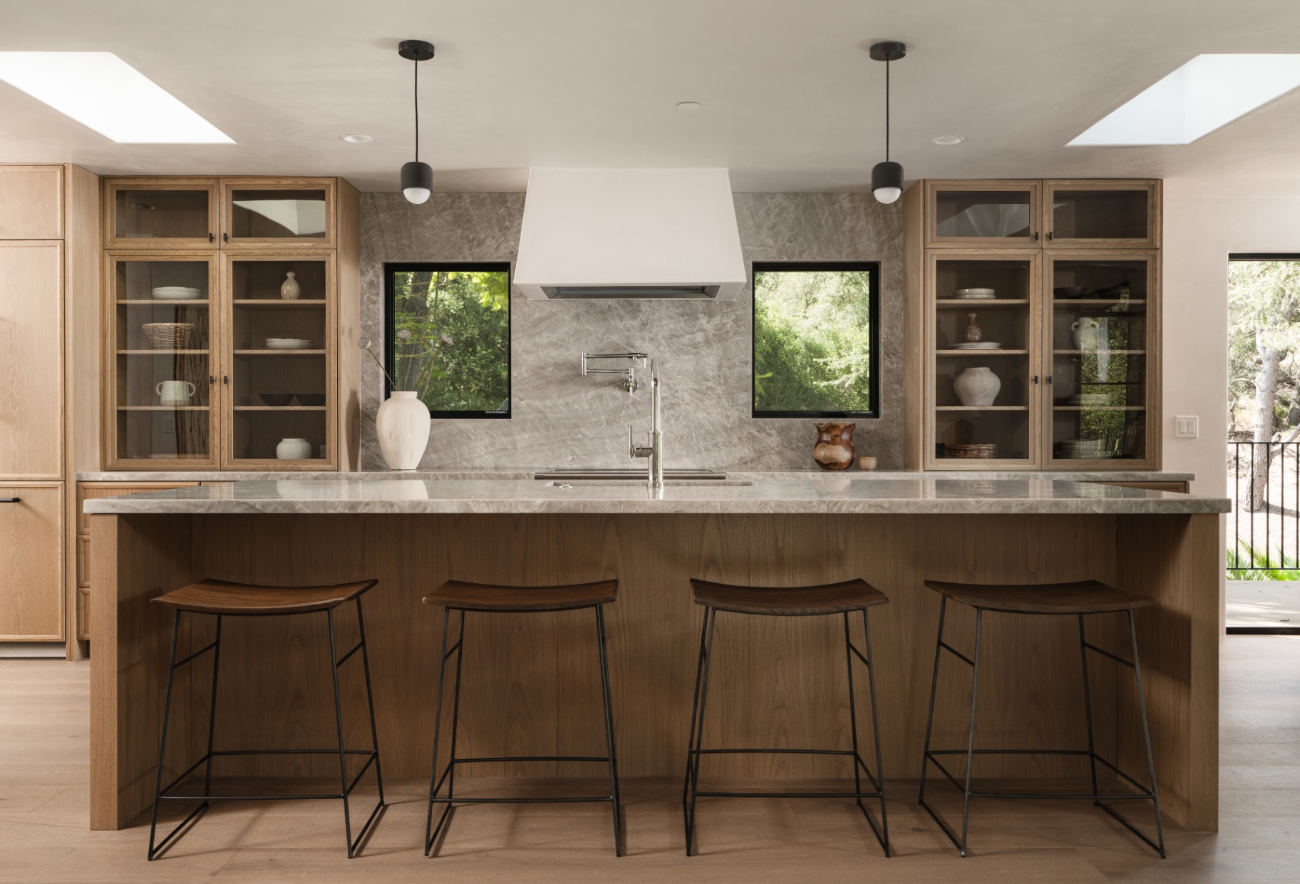 Kitchen island with twin vitrines and full stone surround