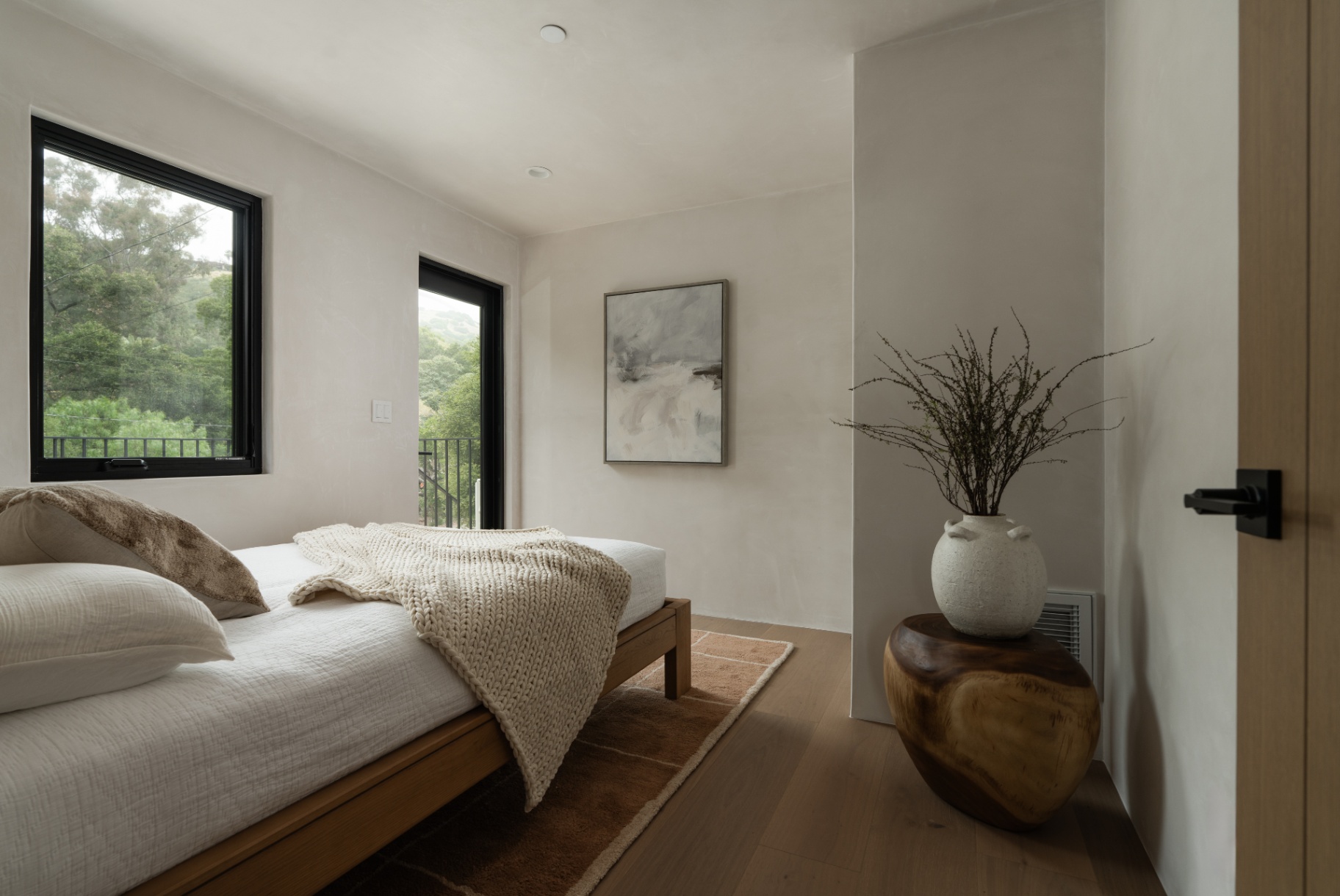 Bedroom in soft natural textures with canopy views