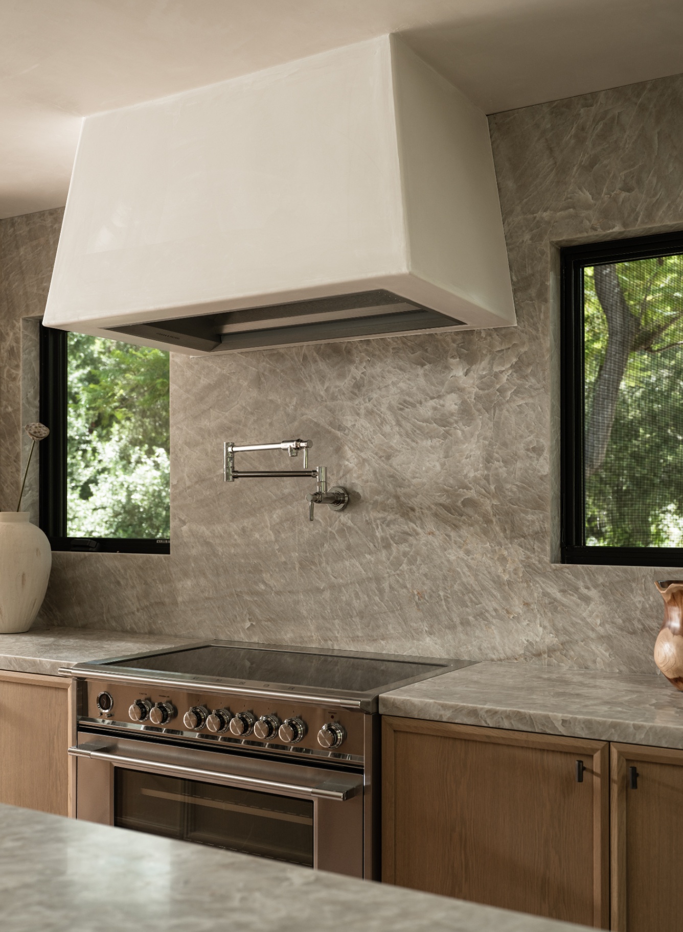 Textured backsplash framing the stainless range