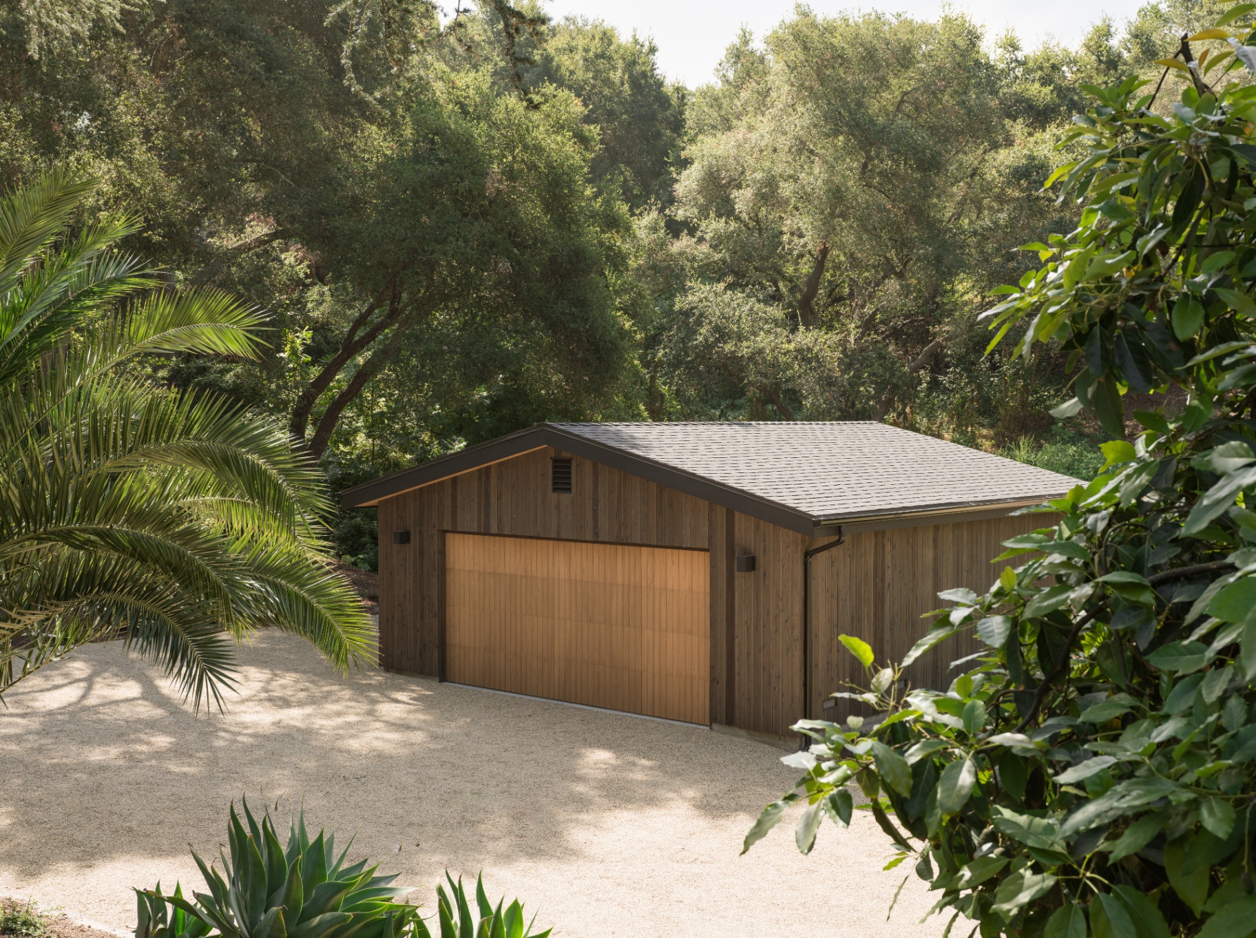 Standalone two-car garage along the planted drive