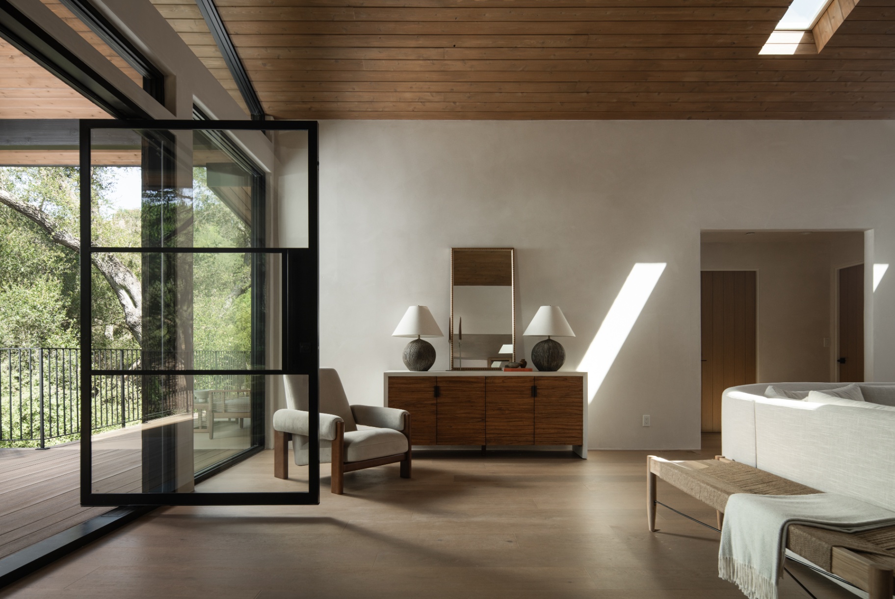 Living room opening through the steel pivot door
