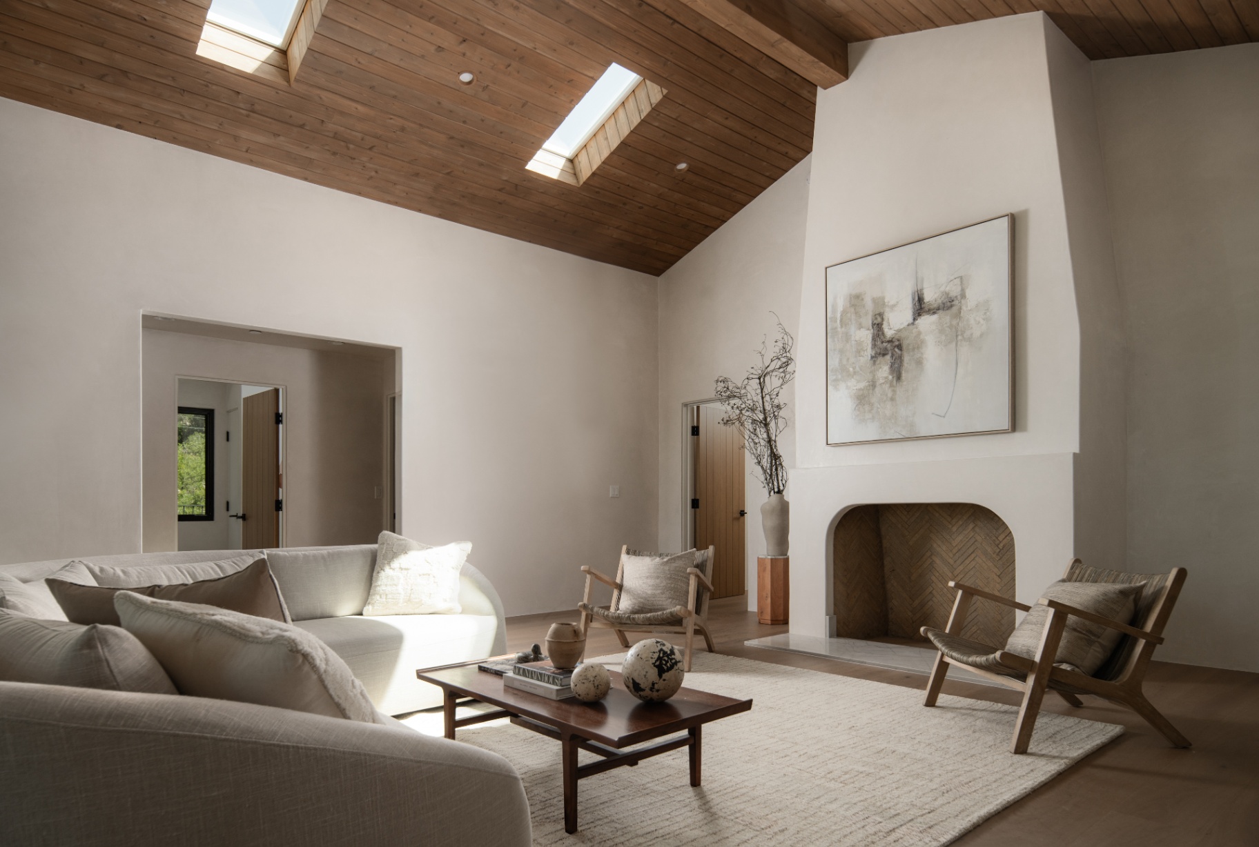 Living room with skylights and the tall plaster fireplace