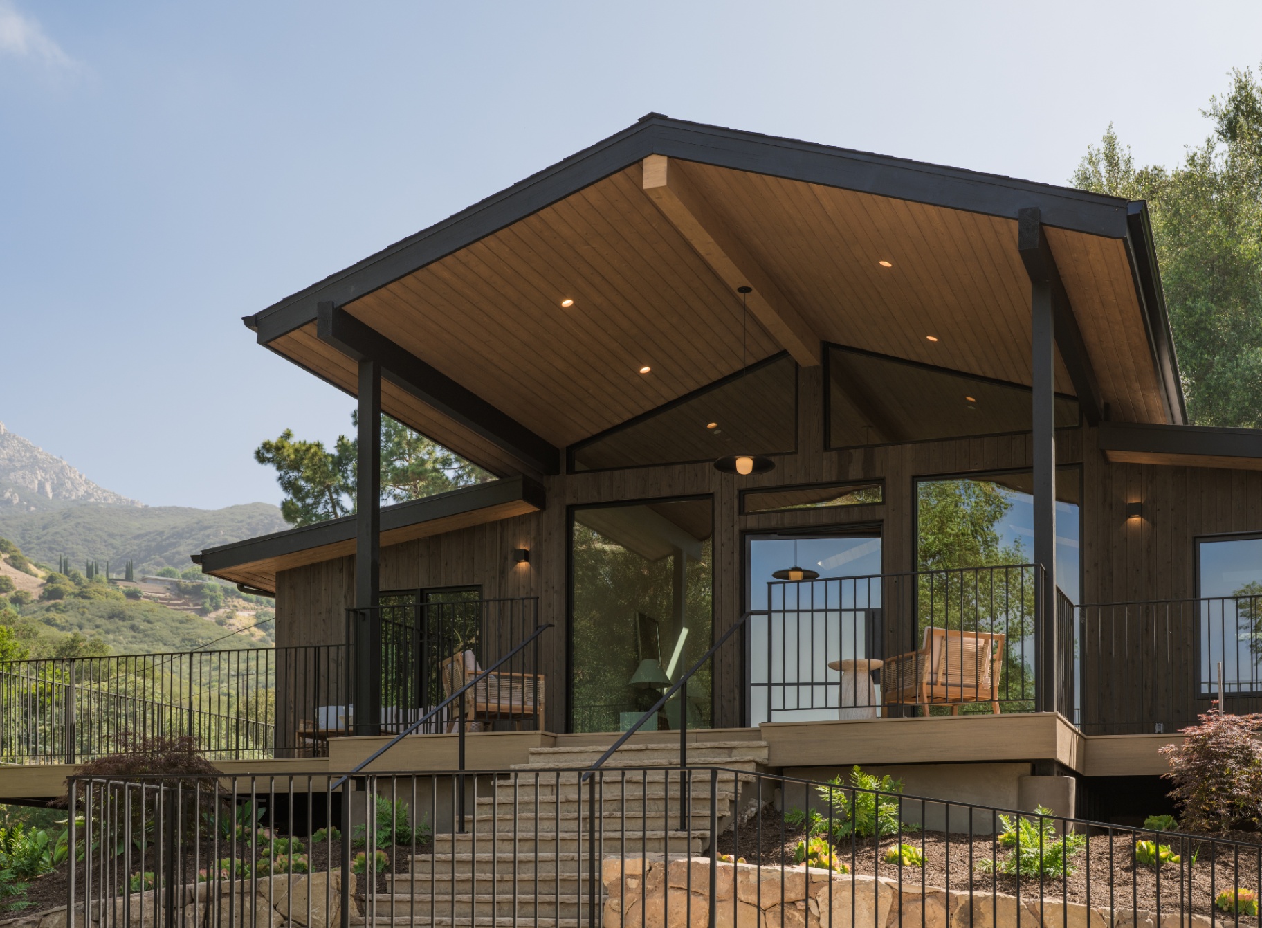 Charred-cedar volume with glazing and cantilevered deck