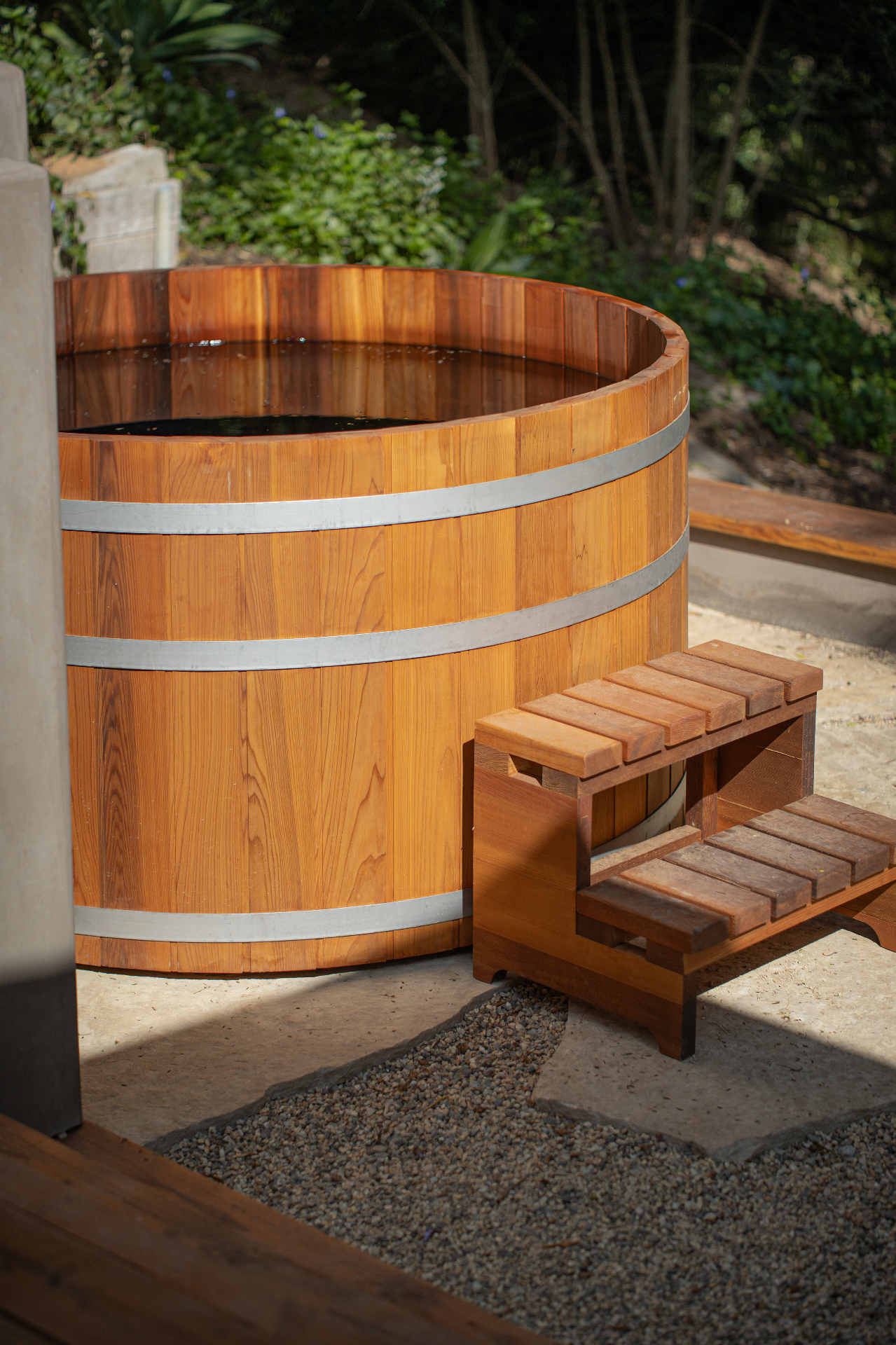 Cedar soaking tub tucked into the landscape