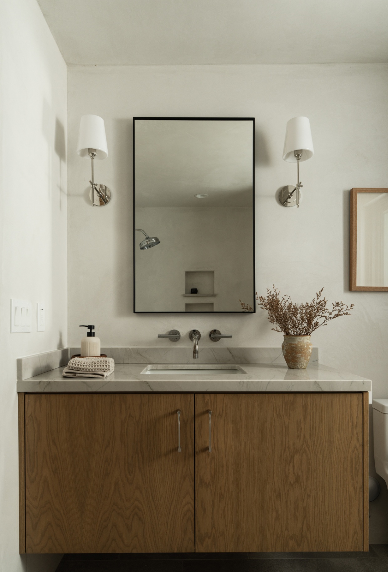Vanity in soft light with mirrored sconces