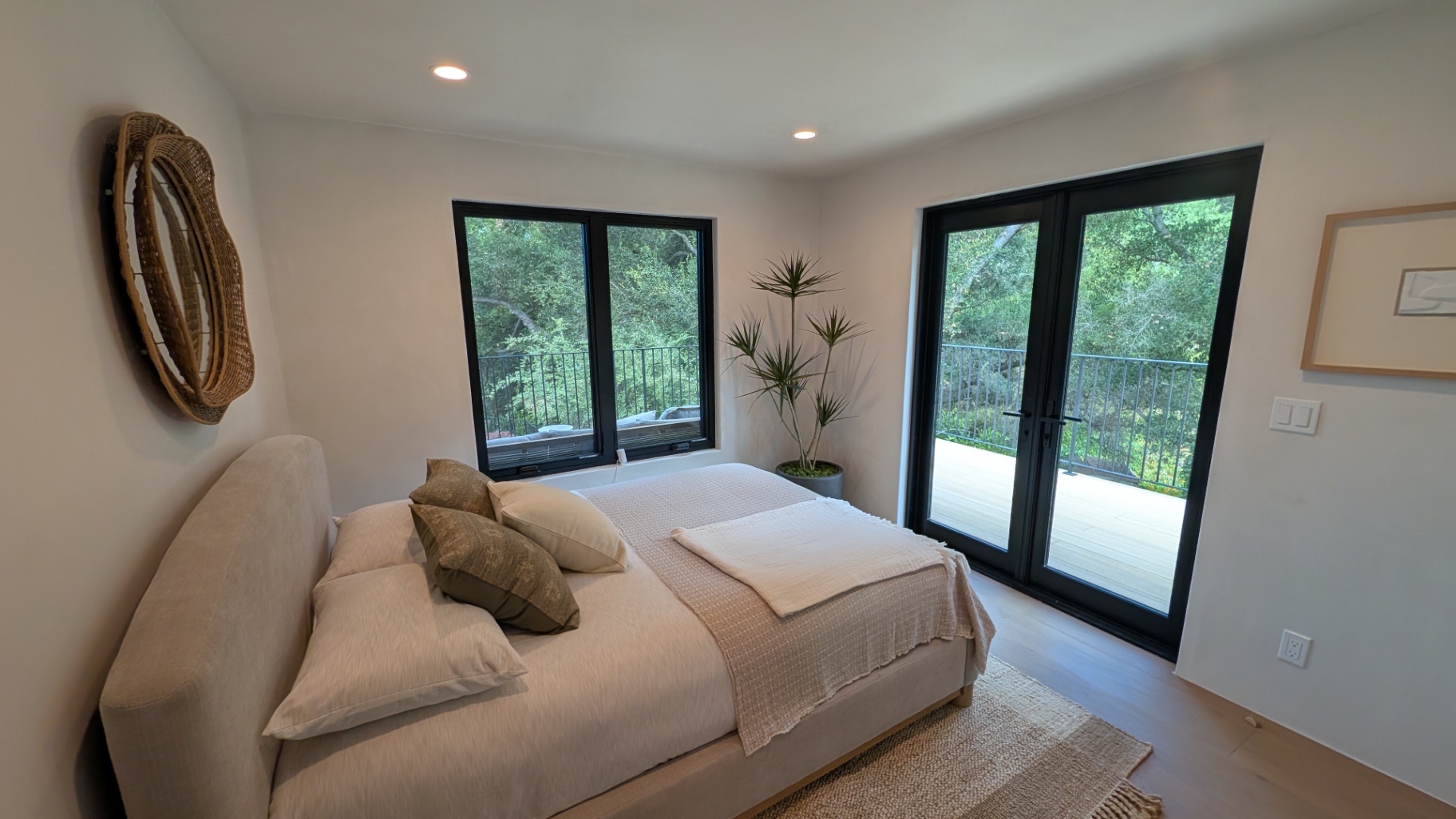 Guest bedroom opening to a private balcony