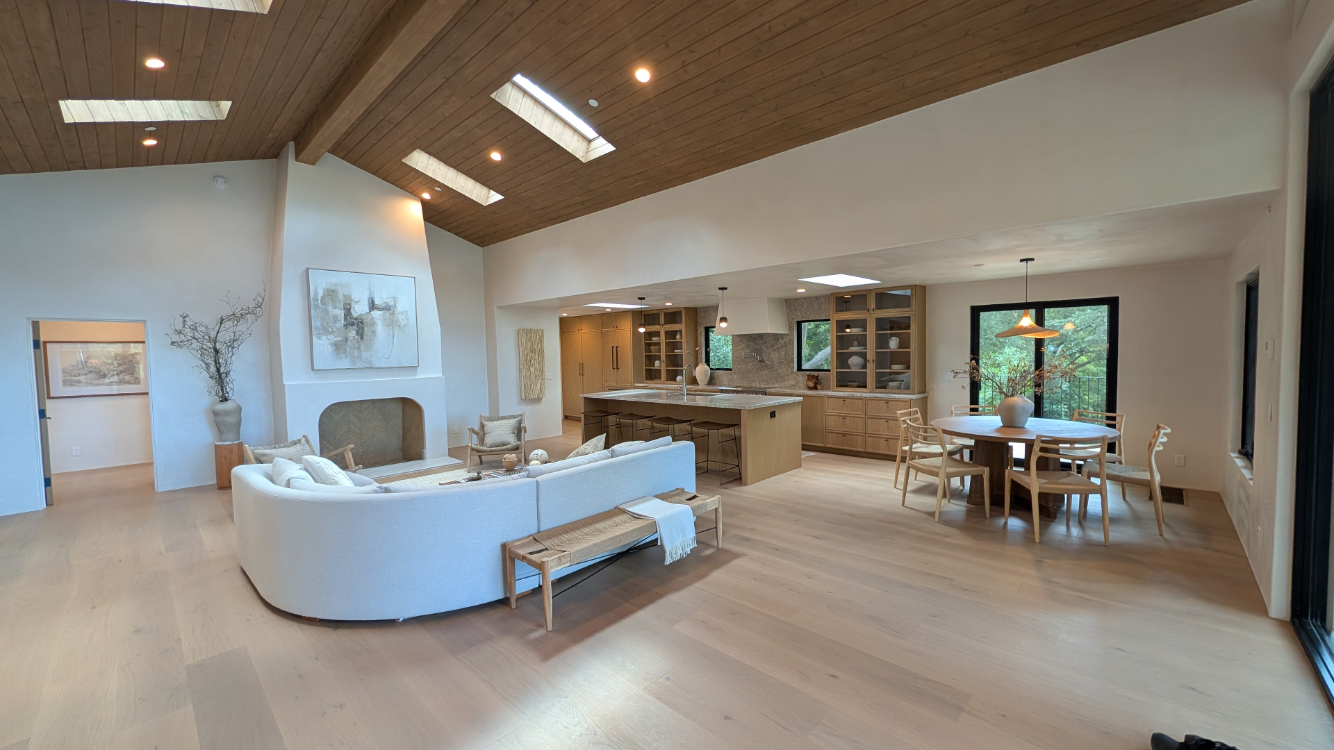 Main living, dining, and kitchen beneath the cedar ceiling