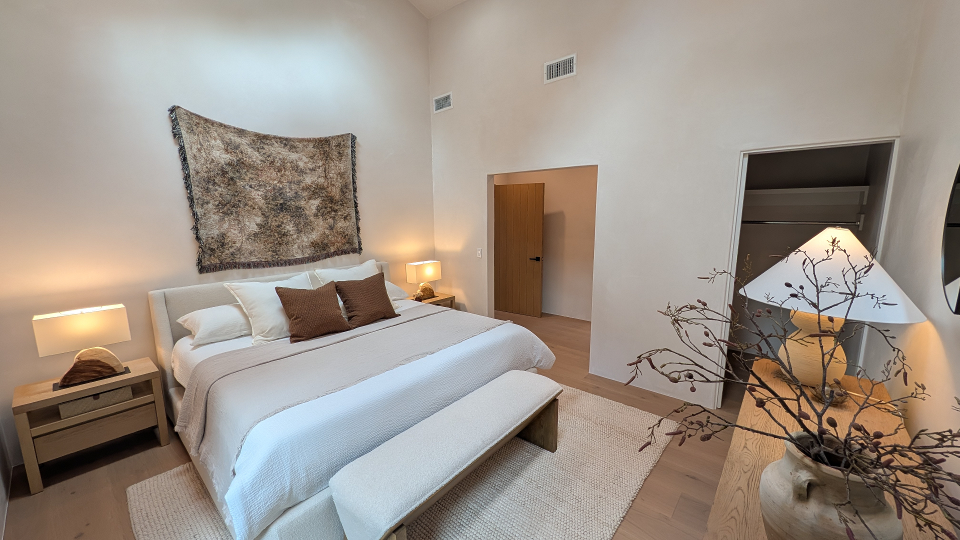 Primary bedroom in warm natural tones